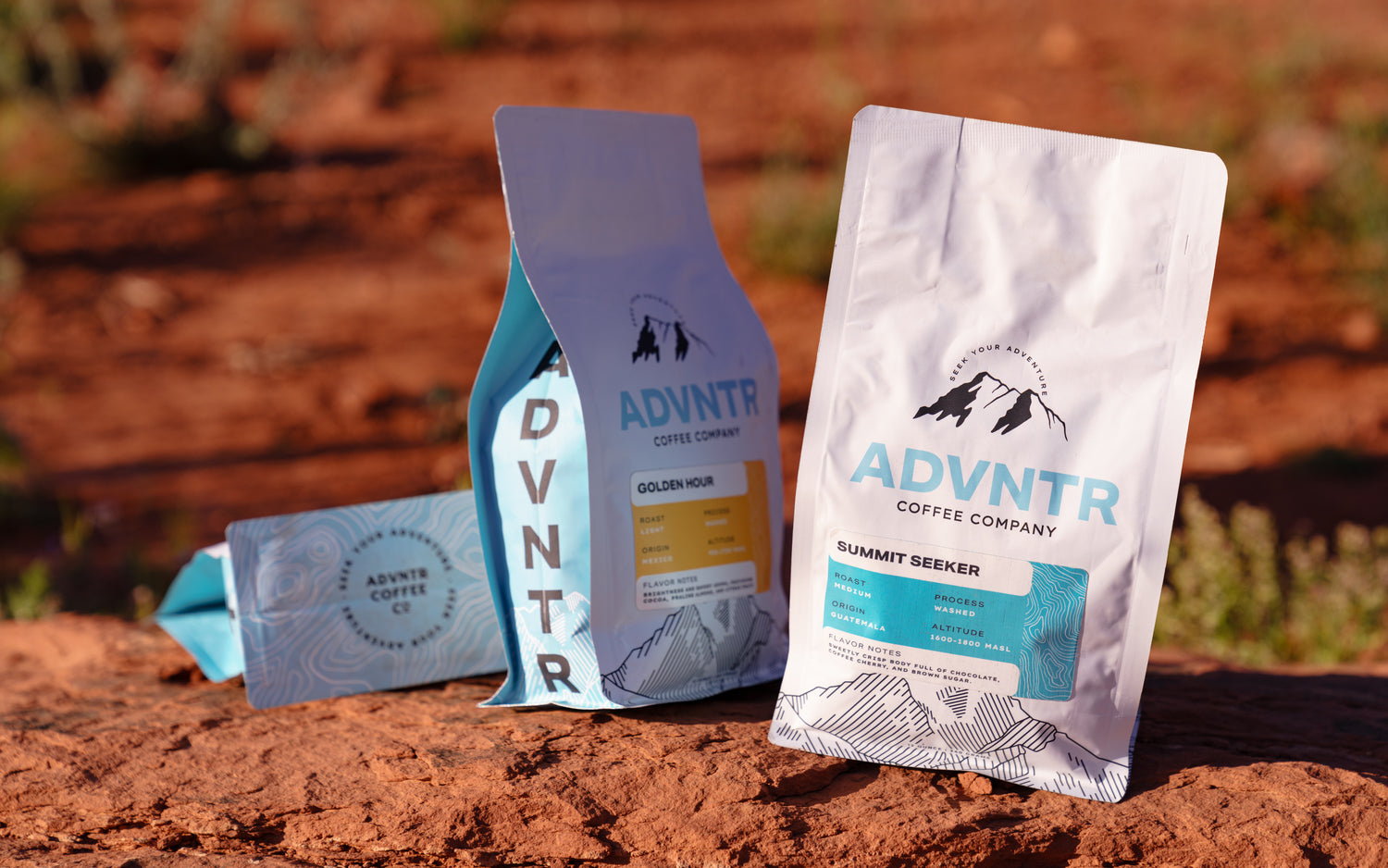 Three bags of ADVNTR Coffee sitting on red rocks in Sedona Arizona