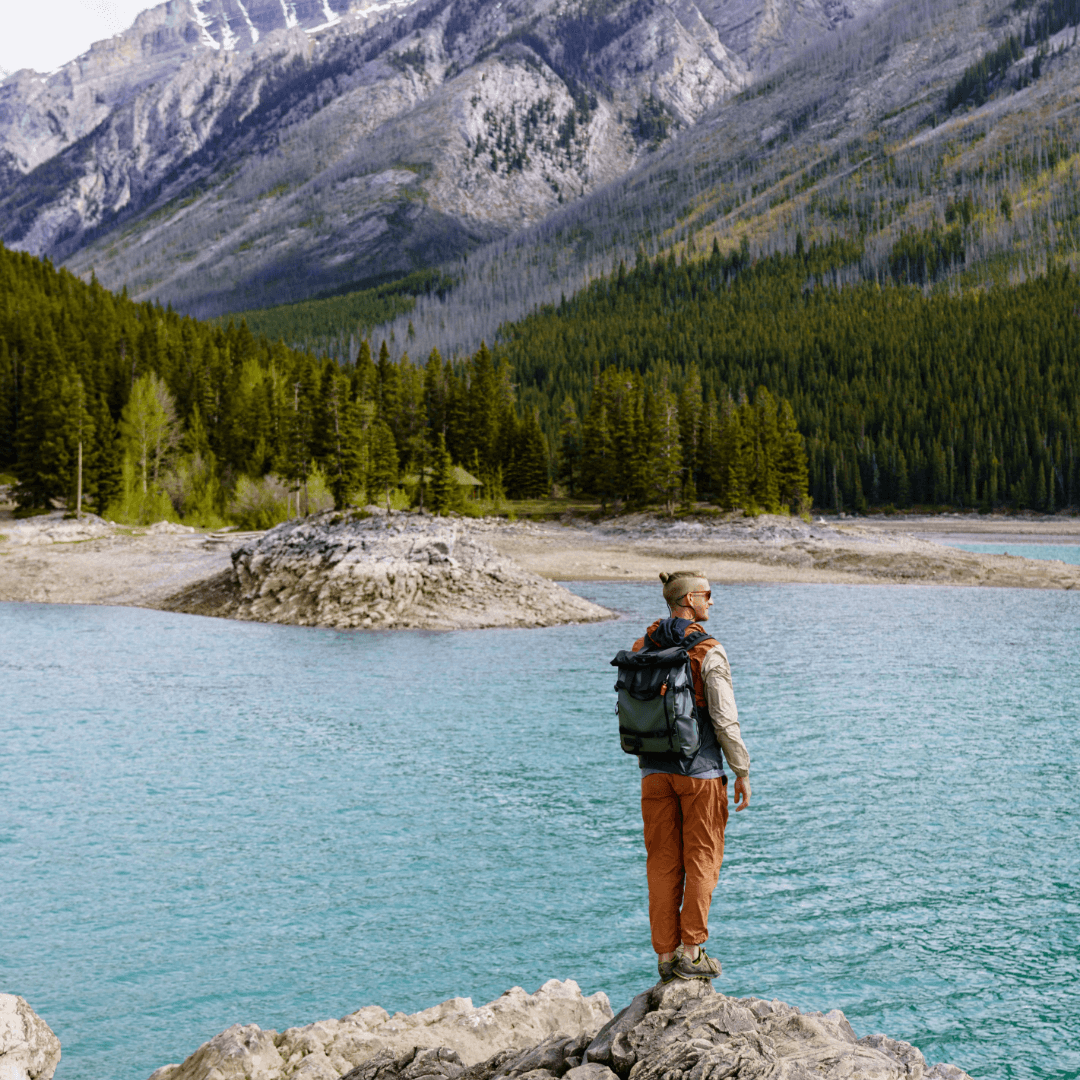Sheridan from Outsidevibes standing on rock at Banff National Park with WANDRD Backpack on